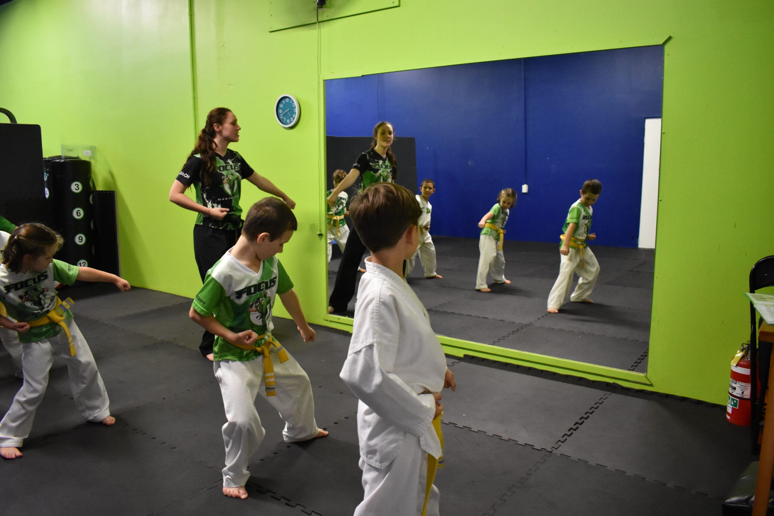 Taekwondo supports mental well-being, enhances cognitive function, and encourages personal growth by helping children set goals, track their progress, and develop a strong sense of success and ability.