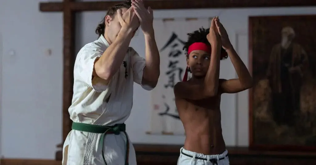 Instructor guiding student through blocks in beginner karate guide