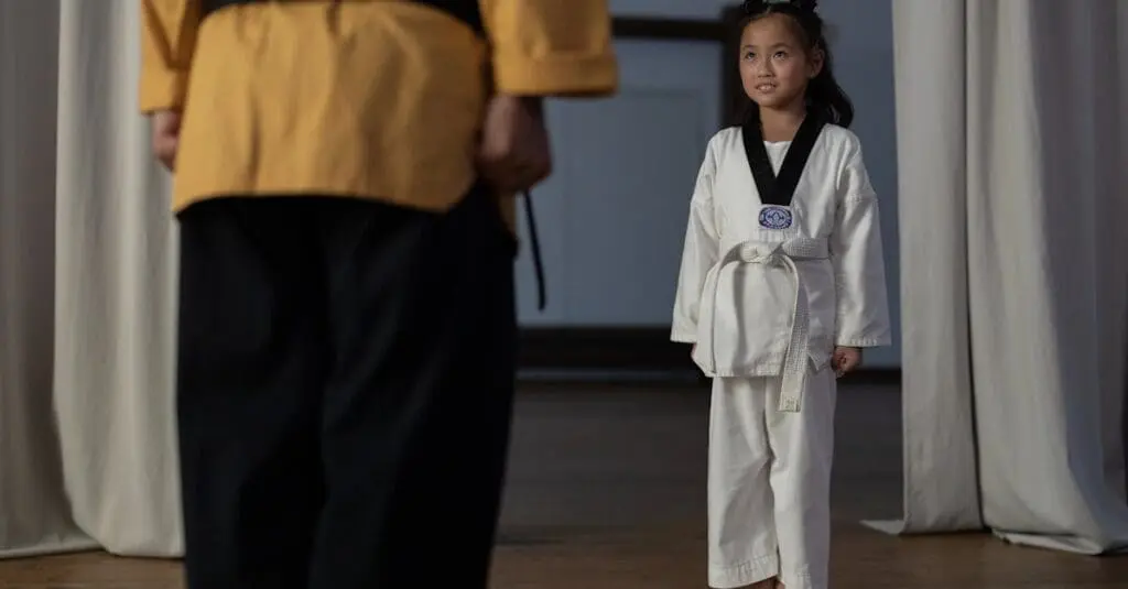Young student learning discipline through a taekwondo training guide for beginners