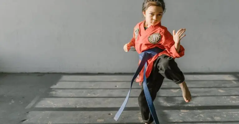 Child performing balance drills during taekwondo training for beginners