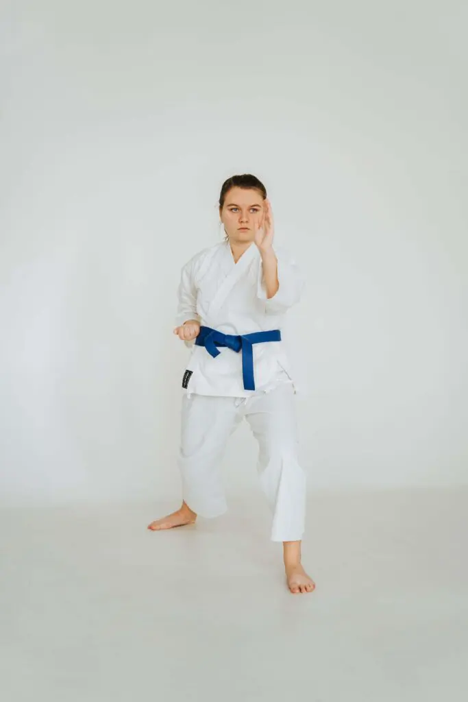 Karate practitioner holding a forward stance while performing an open-hand block during kata training, karate kata meaning